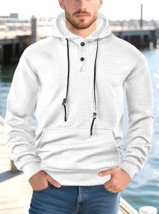 Detail of white men's hoodie featuring geometric jacquard texture and black contrast drawstrings