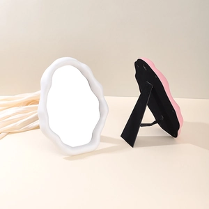 Detail of Nordic cloud makeup mirror with white wave frame and foldable back stand
