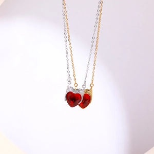 Gold and silver stainless steel necklaces featuring red heart zircon pendants on white background