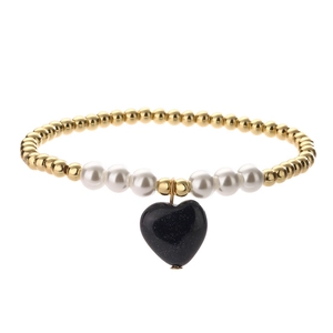 Detail of beaded bracelet with gold metal beads, white pearls and blue heart charm
