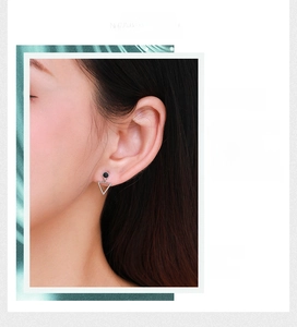 Close-up of minimalist S925 silver hollow triangle earrings worn by a model