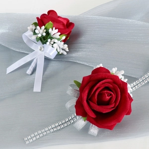 Red velvet rose boutonniere and wrist corsage set for wedding ceremonies with silver ribbon