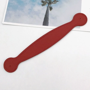 Detail of dark red lychee grain leather wrist strap with reinforced edge stitching