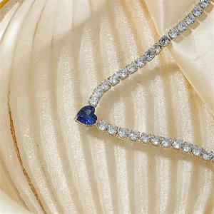 Exquisite silver necklace with round clear zircons and a heart-shaped blue gemstone pendant