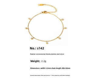Detail of gold stainless steel anklet with cubic zirconia charms and lobster clasp
