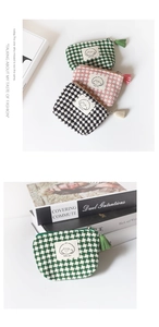 Detail of checkered mini coin purses with tassels and happy girl patches in three colors