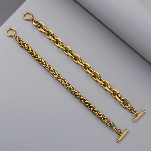 Detail of two gold stainless steel chains with OT toggle closure and thick O-link design