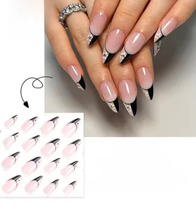 Detail of French almond press-on nails with black borders, white flowers and small rhinestones
