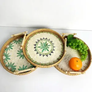 Three-piece nesting set of round woven rattan trays with shell inlay floral patterns