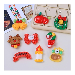 Flat lay of 8 colorful Christmas resin charms for DIY crafts featuring deer and bells