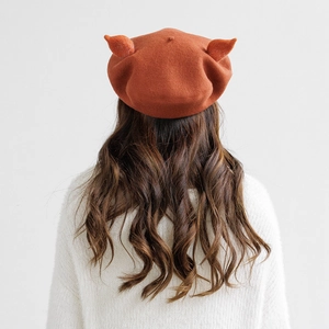 Detail of cute deer antler caramel beret with soft wool felt texture on model