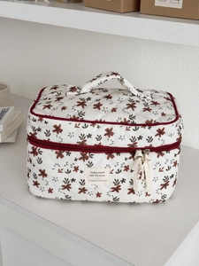 Quilted floral makeup bag with orange flowers, zip handle and vintage textile label