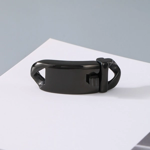 Macro view of polished black magnetic jewelry clasp on a white card for DIY crafts