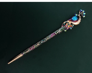 Detail of vintage peacock hair pin with colorful crystals and enamel flower patterns