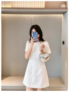 Silver mirror heart-shaped acrylic clutch bag with metal chain strap shown on model