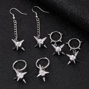 Silver punk earrings with spiked metallic balls and gothic chain in a minimalist dark setting