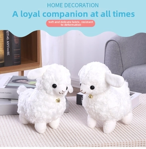 Close-up of plush white lambs with golden bells and soft curly wool texture details