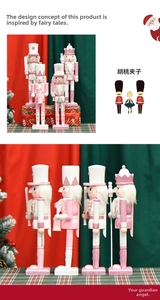 Close-up of glittery pink nutcracker king ornaments with sword and drum details