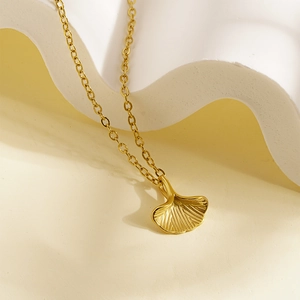 Minimalist golden ginkgo leaf pendant necklace for women with elegant cross chain detail