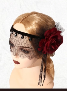 Detailed close-up of vintage black mesh veil with dark red flower for Gatsby parties
