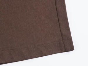 Detailed close-up showing double-needle stitching on dark brown fabric hem