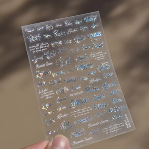 Détail macro de stickers holographiques pour ongles avec lettres anglaises cursives