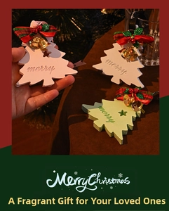 Close-up of handmade Christmas tree gypsum aroma stone with ribbon and bell decor
