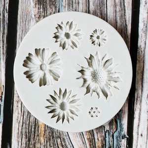 Daisy silicone fondant mold for chocolate and cake DIY on a wooden surface