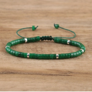 Detail of adjustable woven bracelet with green cylinder stones and silver spacers