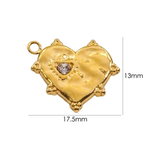 Macro shot showing dimensions of a heart-shaped gold pendant with a clear zircon stone