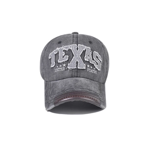 Detailed close-up of Texas embroidery and brown leather trim on a vintage baseball cap