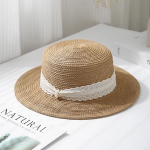 Flat top raffia straw hat with white lace trim and pearl accents for beach vacations