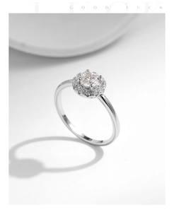 Detail of s925 silver ring featuring a round Moissanite stone and halo setting