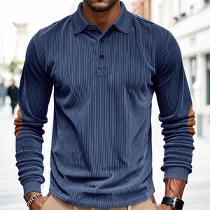 Detail of blue corduroy polo shirt featuring brown elbow patches and ribbed texture