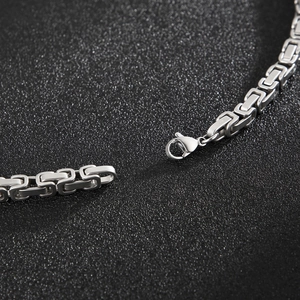 Detailed macro shot of silver Byzantine chain necklace with a secure lobster clasp