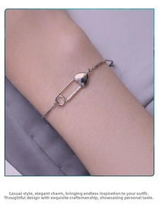 Close-up of S925 sterling silver heart bracelet with sparkling zircon paperclip link on wrist