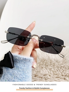 Detail of rimless rectangle sunglasses featuring silver metal cross floral engravings on arms