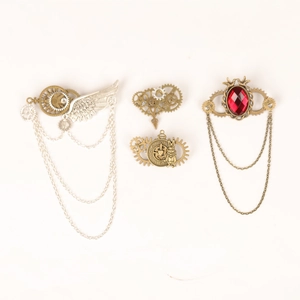 Detailed steampunk gear brooches with metal wings, chains, and a red gem detail