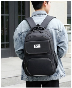Close-up of black business backpack featuring durable fabric and multi-pocket design