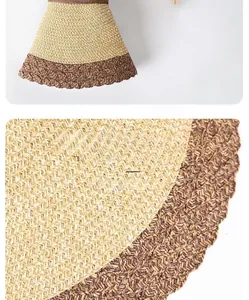 Detail of two-tone woven paper straw sun hat showing texture and wavy brim craftsmanship