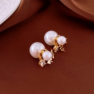 Elegant star flower double-sided pearl earrings with gold plating on brown silk