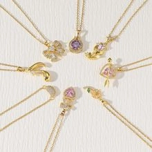 Radial layout of golden necklaces featuring heart, flower, and waterdrop zircon pendants