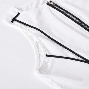 Detail of white ribbed tank top with black zipper and trim, highlighting fabric texture