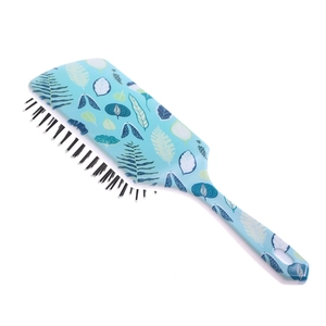 Detail of blue paddle hair brush with green leaf pattern and black massage bristles