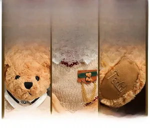 Detail of teddy bear facial features, knit sweater with pendant and embroidery on paws
