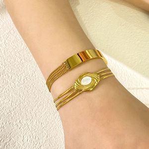 Elegant 18K gold-plated titanium steel bracelet set with natural shells on a female wrist