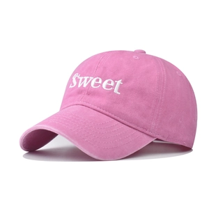 Detailed embroidery of white SWEET text on a pink washed cotton baseball cap