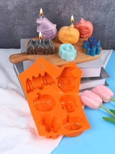 Detailed view of an orange silicone mold for Halloween candles with festive shapes