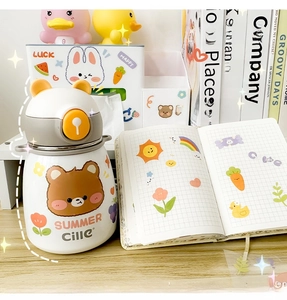 Waterproof cartoon stickers showing cute bear and rabbit motifs on a water bottle