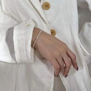 Detail of 925 sterling silver chain bracelet on wrist with elegant texture